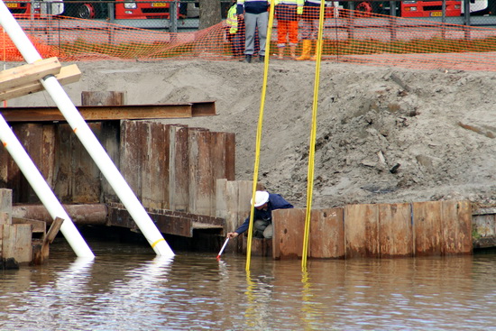 Eerst dacht ik dat de temperatuur van het water werd gemeten, blijkbaar ook van invloed. Toen bleek het zo'n roodwitte puntstok te zijn. Nee, er wordt niet tegen de buizen geduwd, hoogstens gemeten hoe diep het is.....