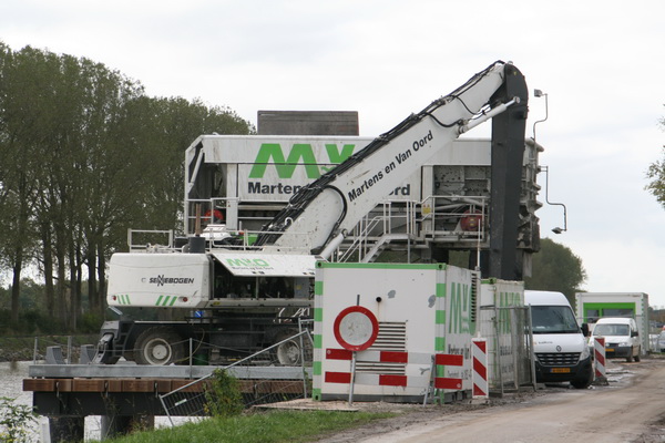 Op de tijdelijke aanlegsteiger (noord) is de grote grijper van Martens en Van Oord in diep gepeins verzonken.... Geen schip te bekennen... Monteurs bezig met onderhoudswerk?