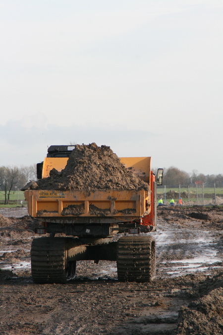 Daar gaat ie, het rupswagentje! En alle afgegraven grond wordt hergebruikt! Verderop, bij de taluds van de nieuwe weg + vaste hoge brug..... 